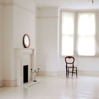 living room with white wall and chair