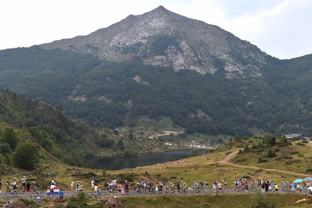 The peloton rides through the mountains during stage 12.