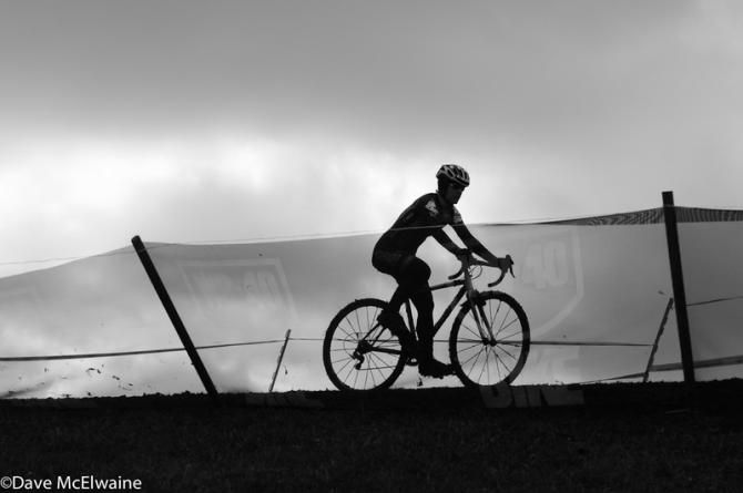 A rider crosses the ridge at the top of the course