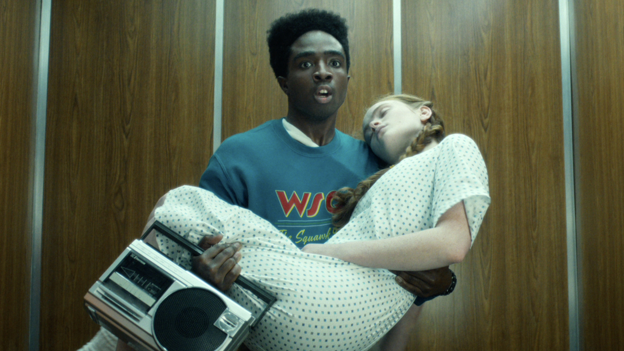 Lucas Sinclair (Caleb McLaughlin) carries Max Mayfield (Sadie Sink) in Stranger Things.