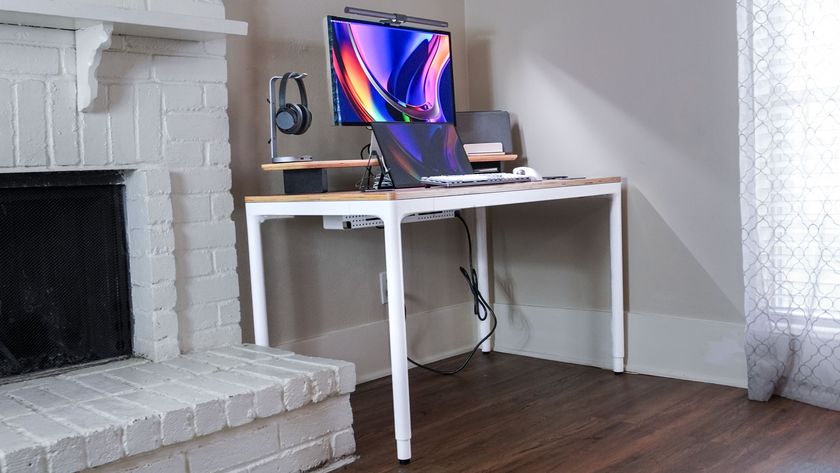 The Branch Four Leg Standing Desk set up in the corner of a living room