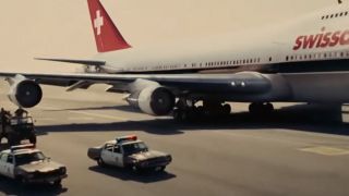 Police cars driving alongside a 747 in Argo