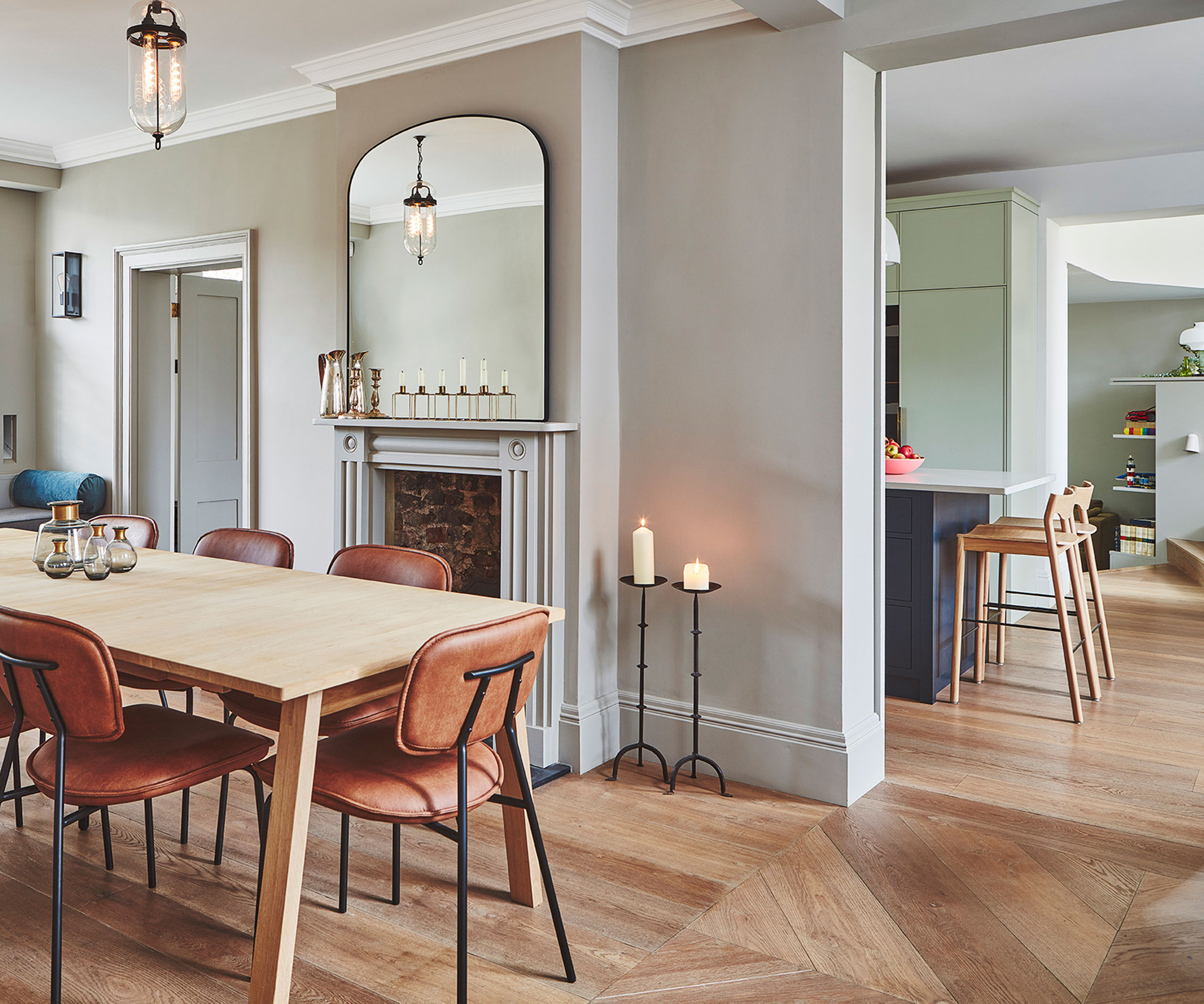 dining room with two doorways into kitchen beyond