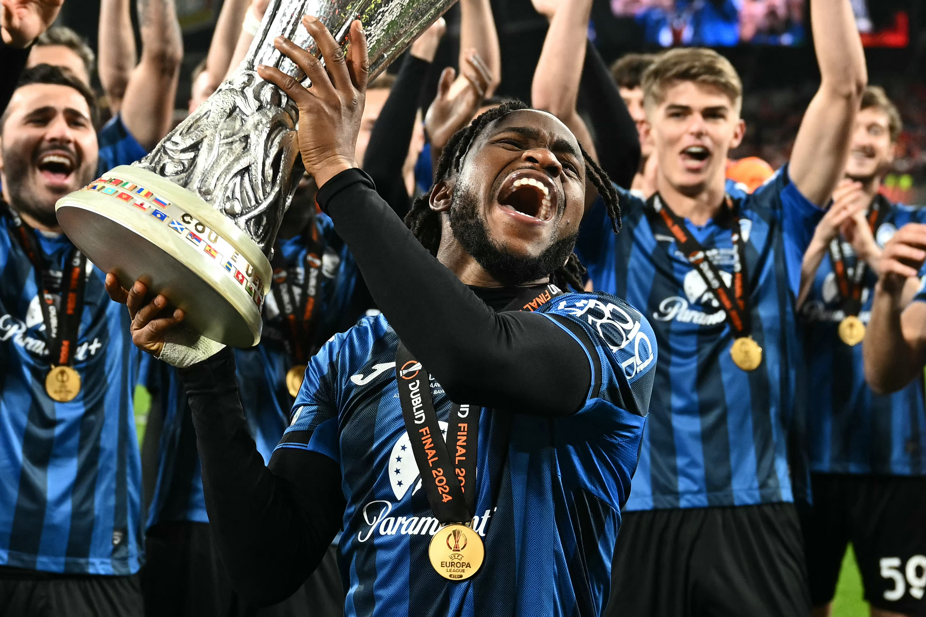 Ademola Lookman celebrates with the Europa League trophy after hitting a hat-trick for Atalanta against Bayer Leverkusen in the 2024 final.
