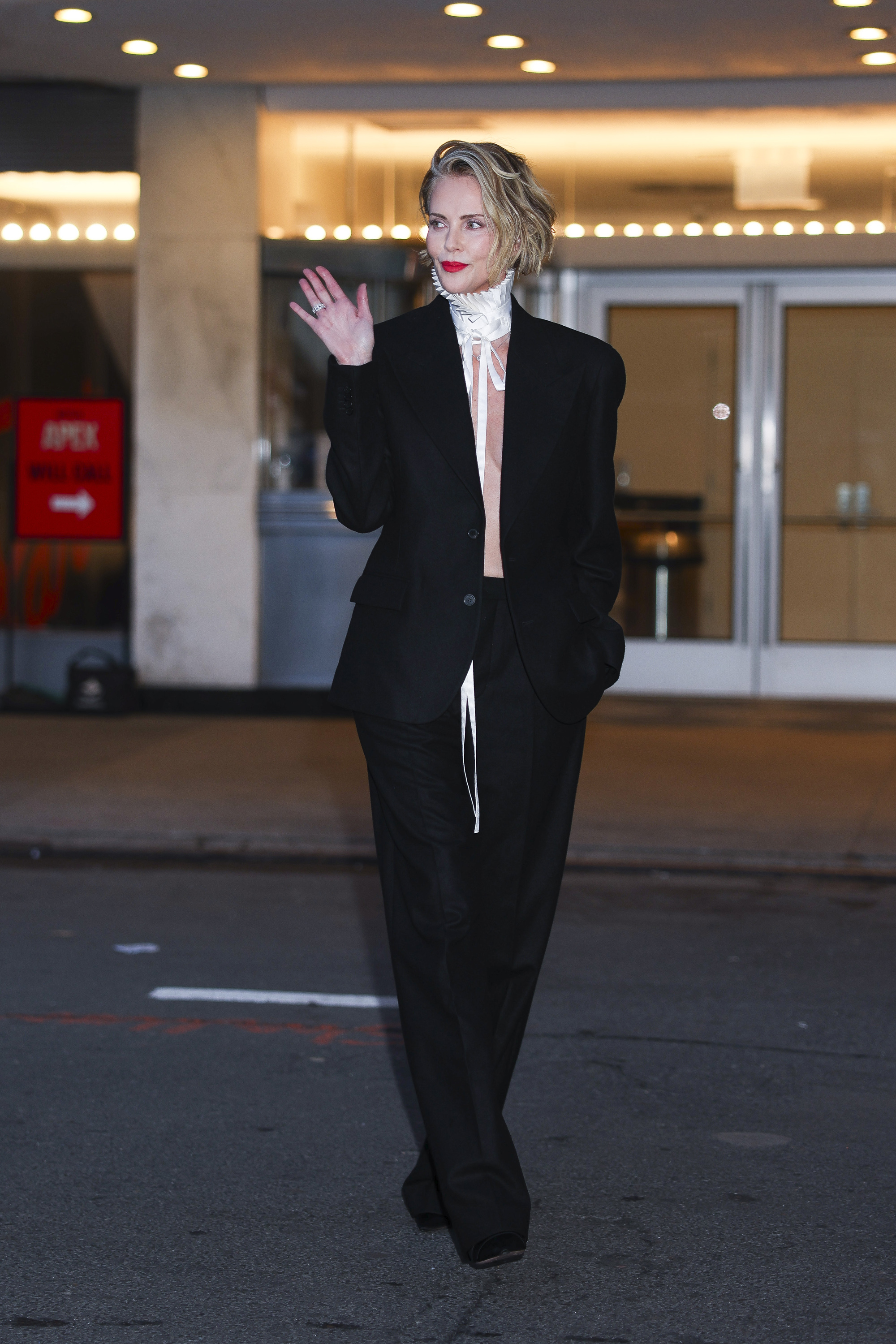 charlize theron on the apex press tour wearing black and white outfits