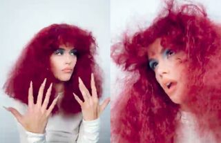 Model Kaia Gerber in a red frizzy wig