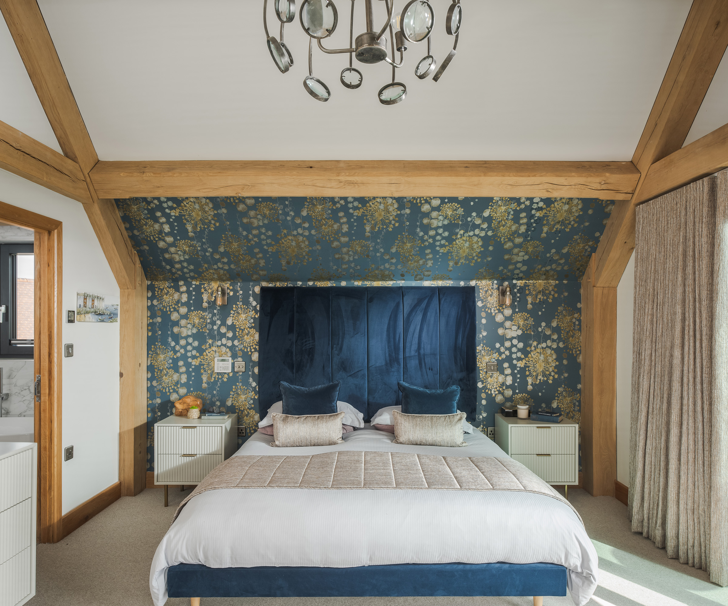 Super king bed in a timber frame bedroom with exposed oak beams