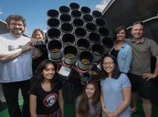 Roberto Abraham (far left) from the University of Toronto, Pieter van Dokkum (far right) from Yale University, and their team of Toronto and Yale graduate students pose with half of the 48-lens Dragonfly Telephoto Array in New Mexico.