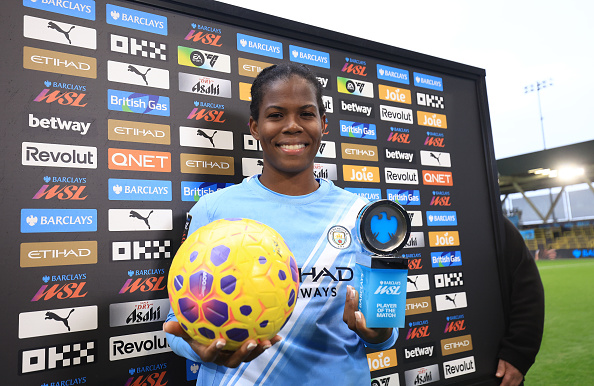 MANCHESTER, ENGLAND - DECEMBER 14: Khadija Shaw of Manchester City poses for a photo with the Barclays WSL "Player Of The Match" award and the match ball after scoring a hat-trick in the Barclays Women's Super League match between Manchester City and Aston Villa at Joie Stadium on December 14, 2025 in Manchester, England. 