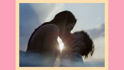 couple in the water kissing as the sun sets
