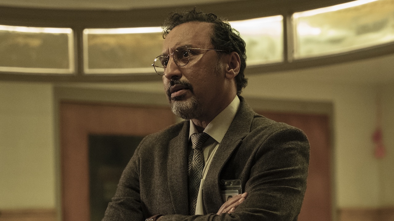 Dr. Anand with arms crossed talking to paitent in The Terror: Devil in Silver