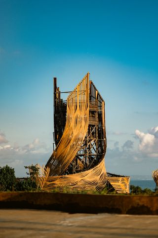 Tri Hita Karana tower seen in light with its twisting volume swirling upwards in bali