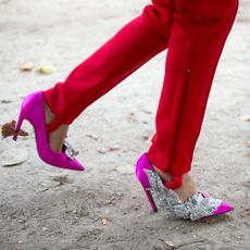 Red stirrup pants and pink high heels.