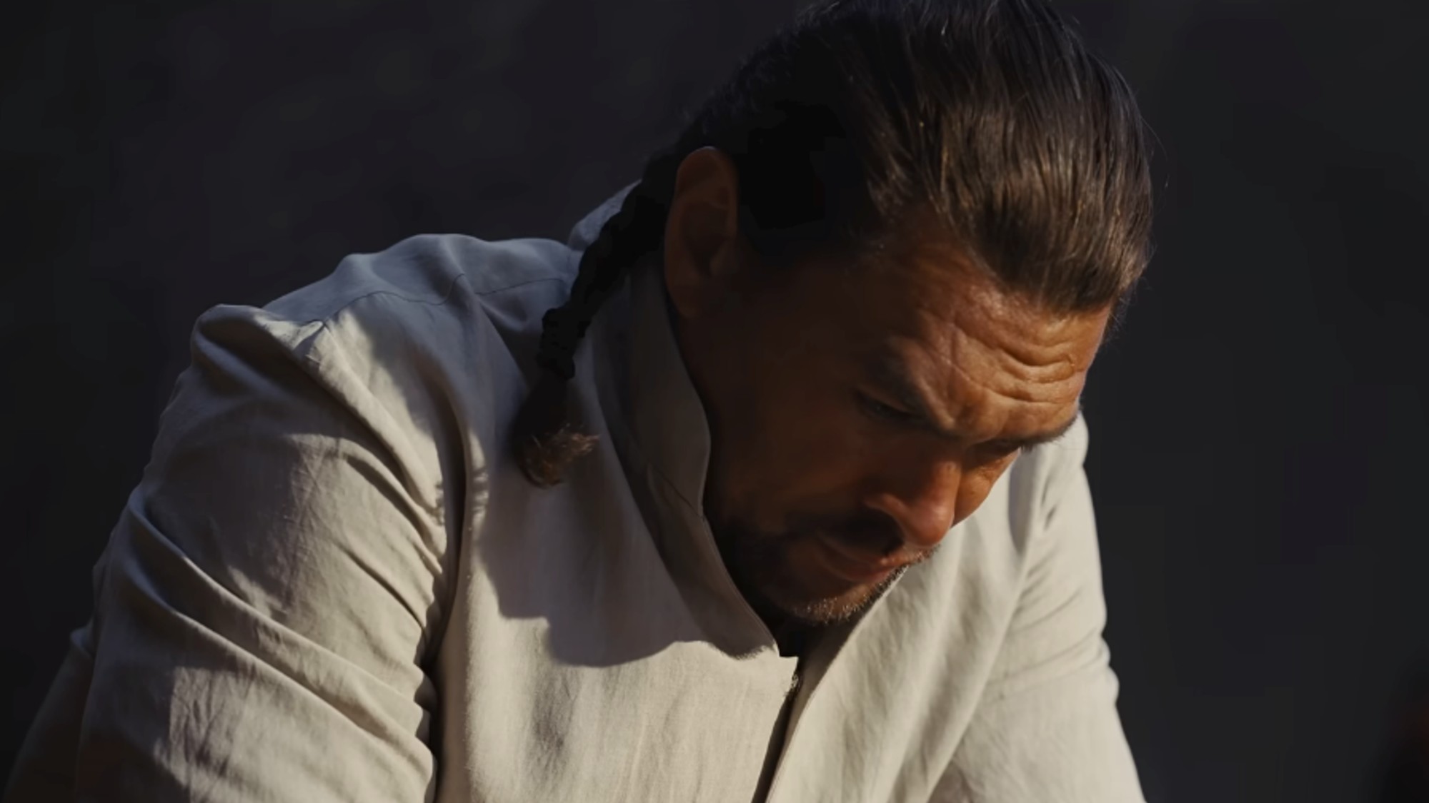 Jason Momoa bowing with his head down, looking at the ground in Dune: Part Three