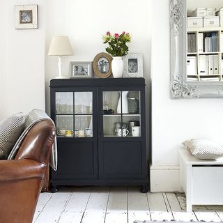 living room with black cabinet and white wall