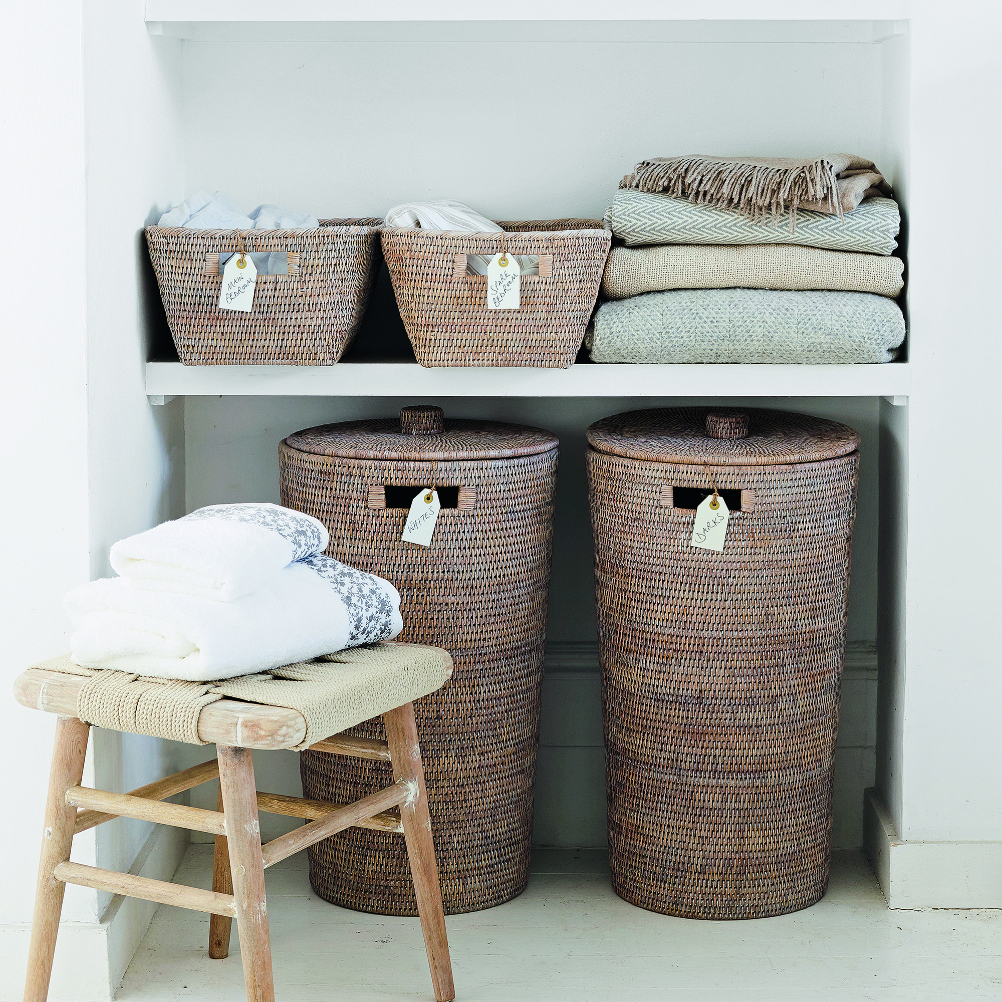 Linen cupboard with rattan baskets and folded towels