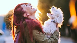 Woman laughing with dog