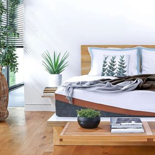 A render of a white bedroom with a wooden floor and wooden platform bed with a white mattress on it