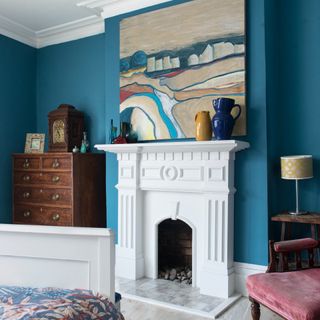 Bedroom with blue walls and fireplace