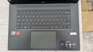 A black Acer Swift Edge 16 laptop sitting on a garden table
