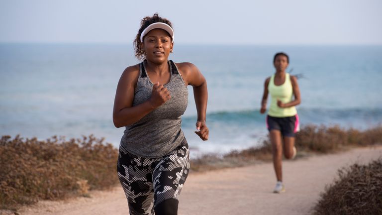 Does running burn belly fat? Women running up a hill