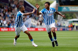 Tino Anjorin of Huddersfield Town celebrates scoring with team mate Sorba Thomas during the Sky Bet Championship between Huddersfield Town and West Bromwich Albion at the John Smith's Stadium on August 27, 2022 in Huddersfield, England