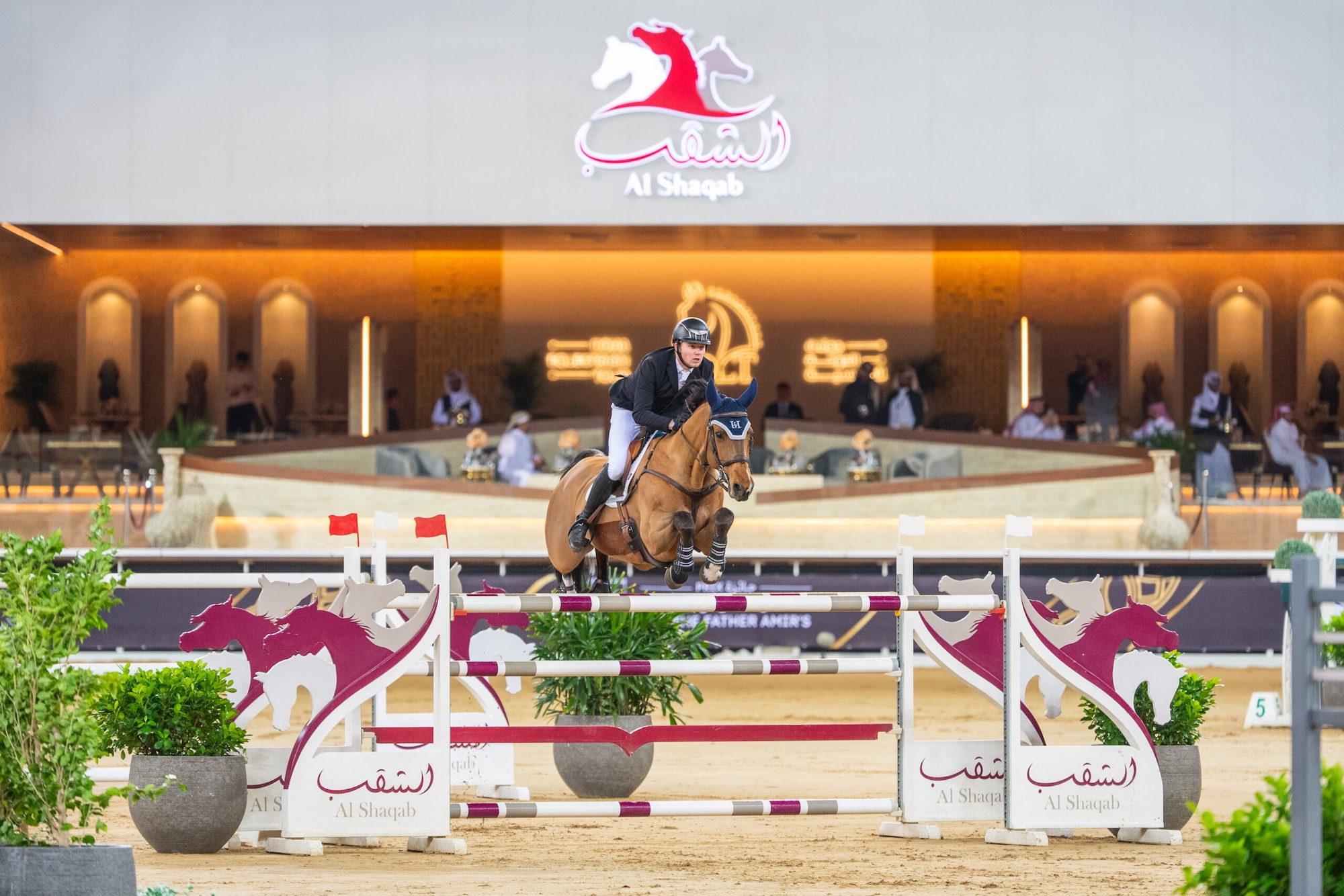 Harry Charles and Casquo Blue clear a large oxer during the CSI4* grand prix in Doha, Qatar.