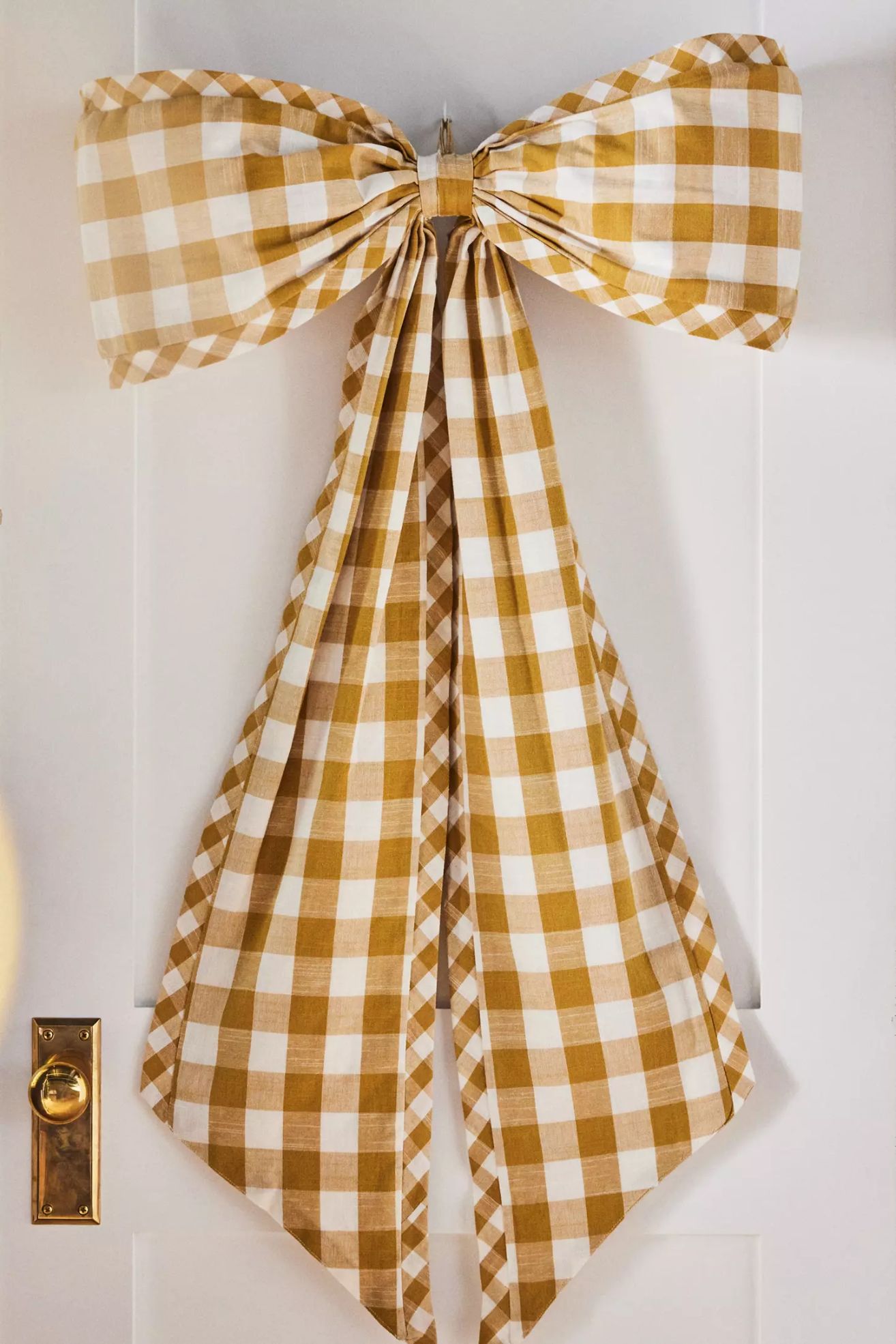 Yellow gingham oversized bow hanging on door
