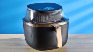 The Phillips Air Fryer 3000 Series pictured in front of a blue background.