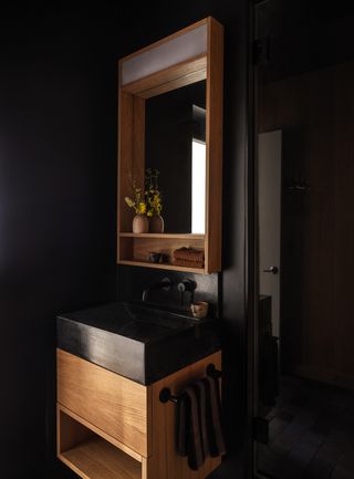 A bathroom with a small, custom vanity