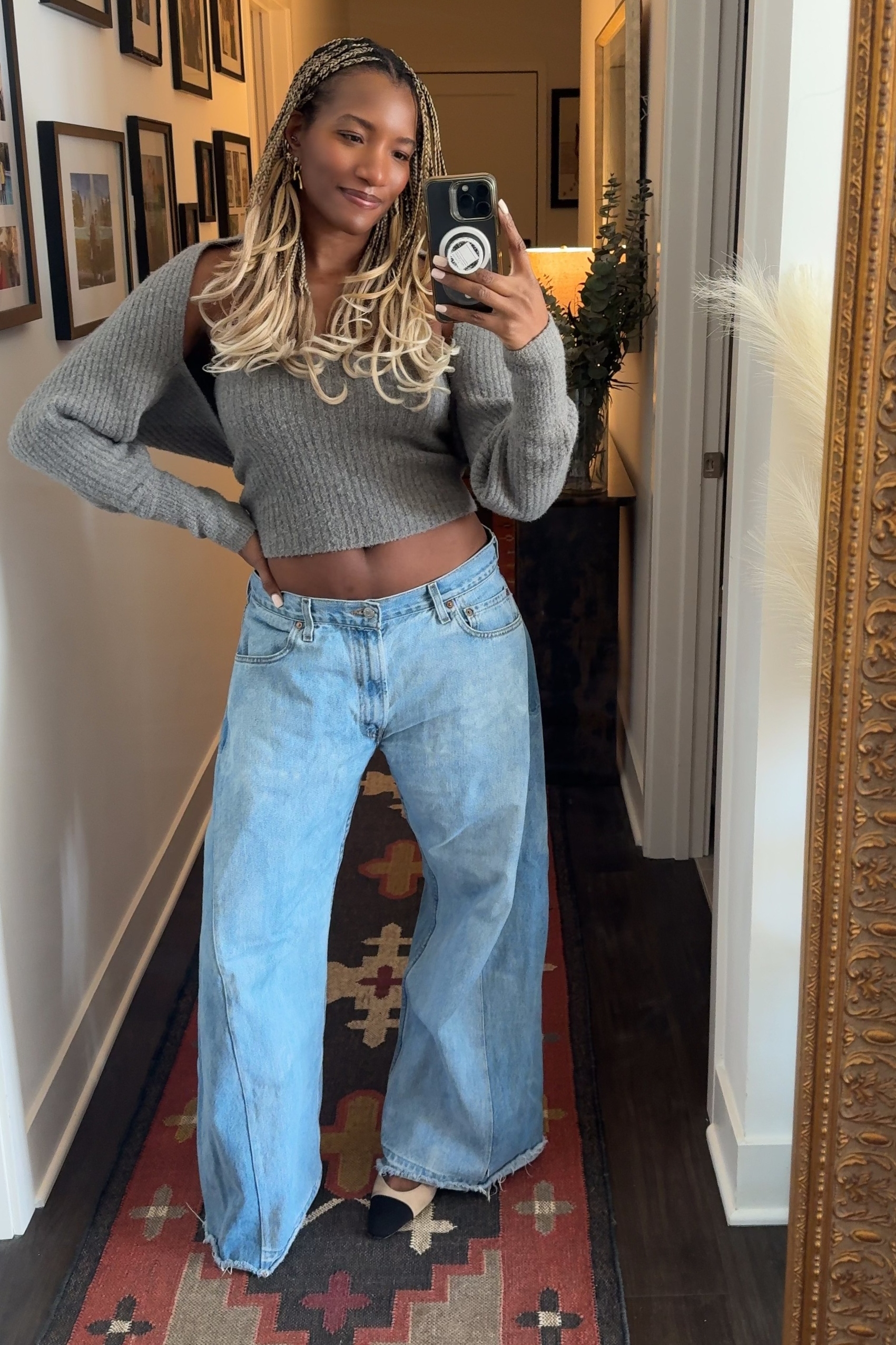 Danielle Prescod wearing a sweater, jeans, and heels