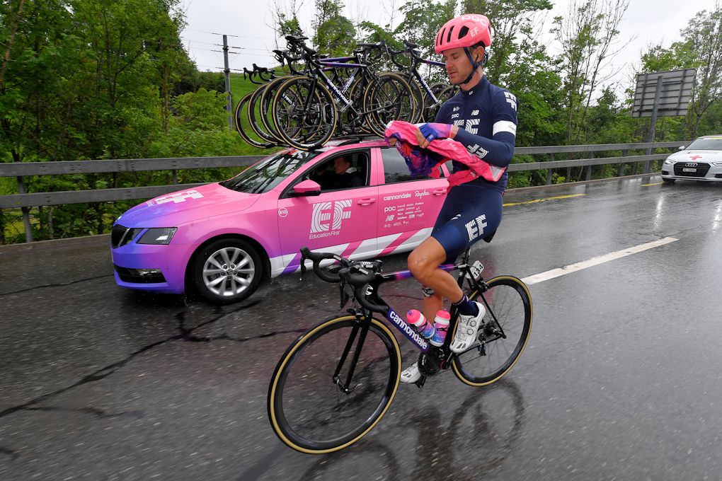 Nathan Brown gets ride of extra layers during stage 6 at Tour de Suisse