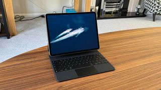 Tablet: Apple iPad Pro 12.9 6th Generation on a desk with marine life on screen