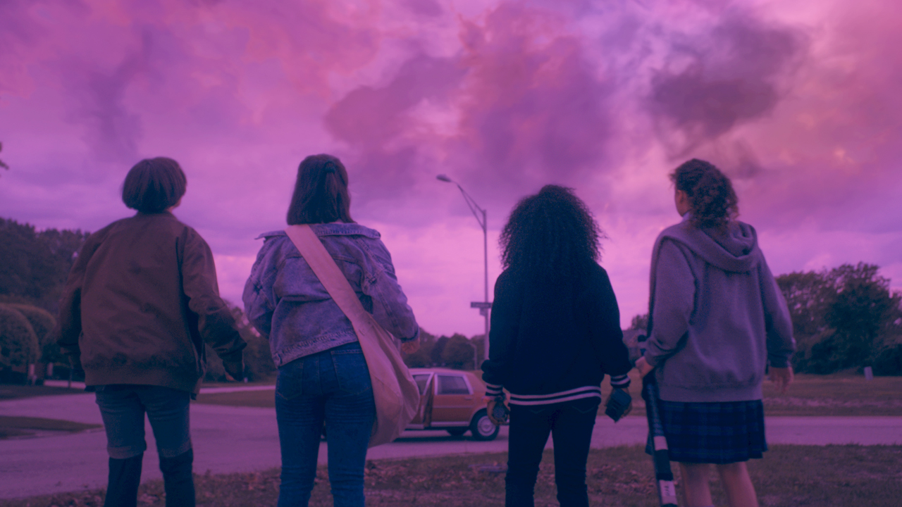 Mac, Tiffany, Erin and KJ stare at a purple, cloudy sky in Prime Video's Paper Girls TV series