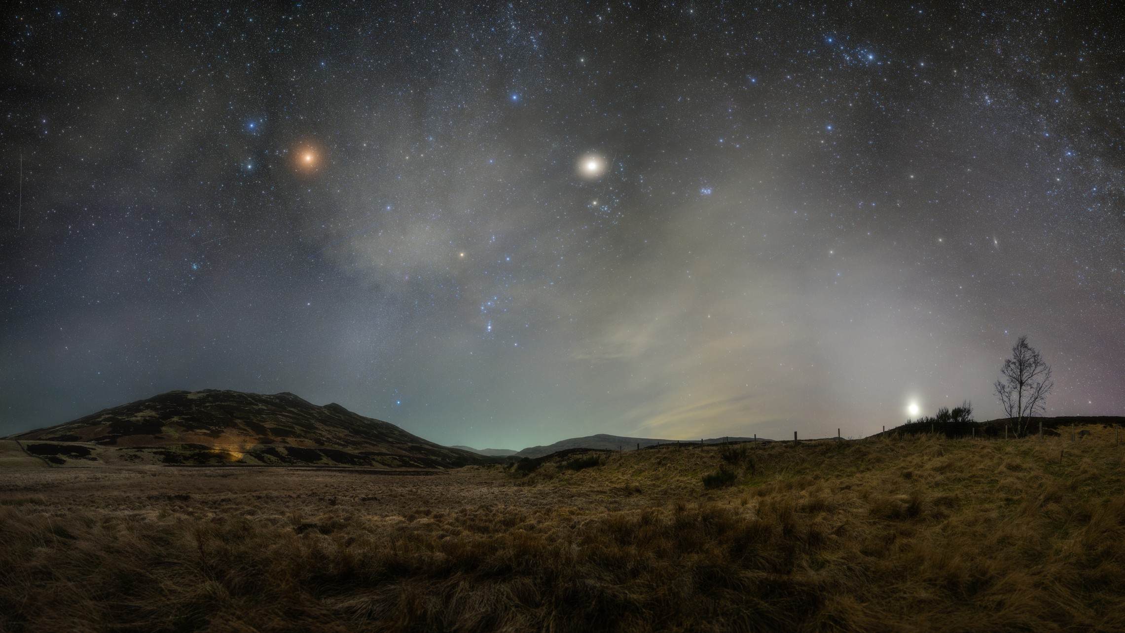 night sky graphic showing mars on the left and jupiter on the right, above rolling countryside.