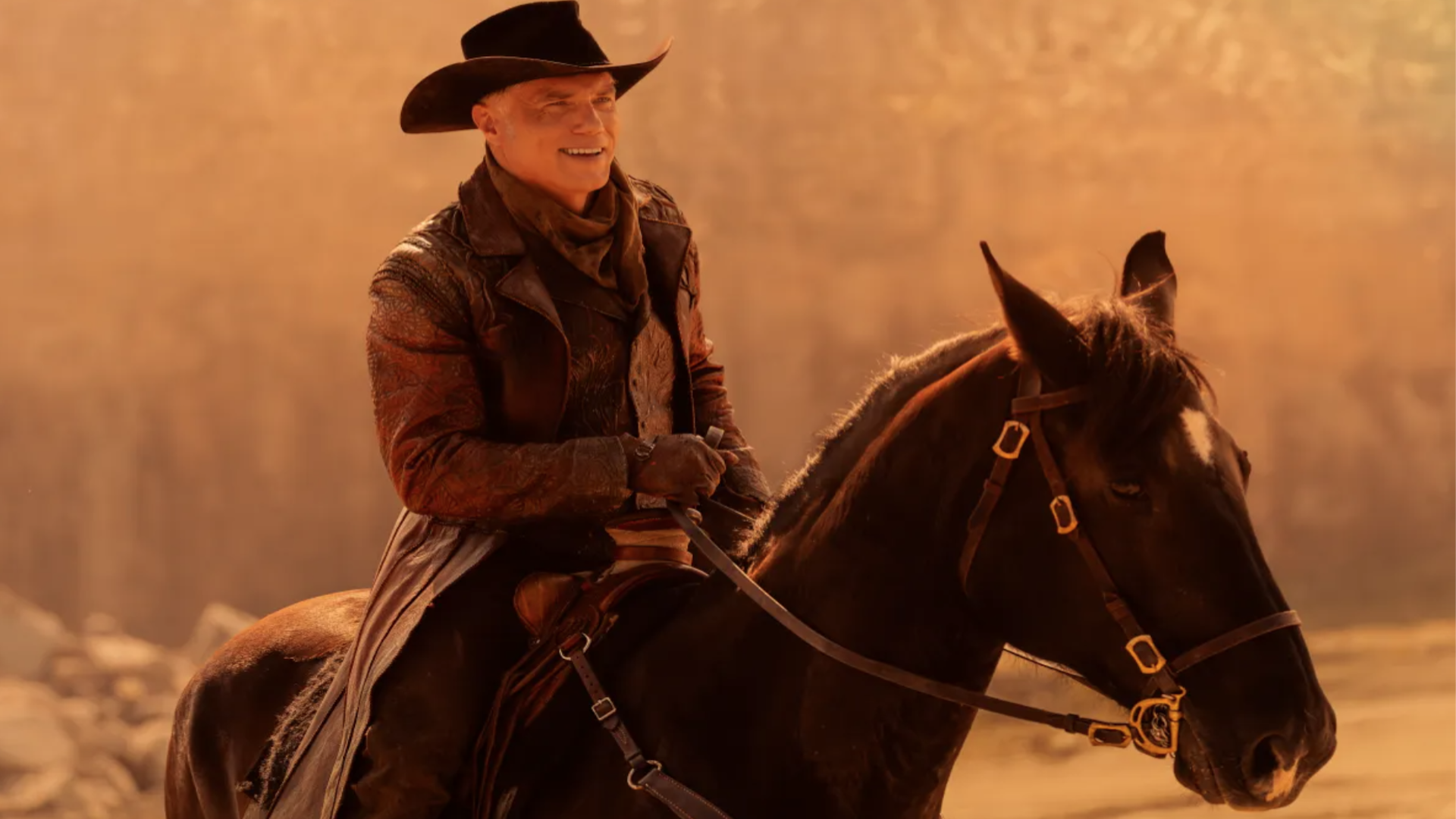 a man wearing western attire riding a horse