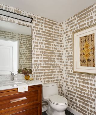 powder room with textured wallpaper and artwork