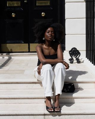 London Summer Shoe Trends: @daniellejinadu wears a black bandeau top with white trousers and black kitten-heel mules