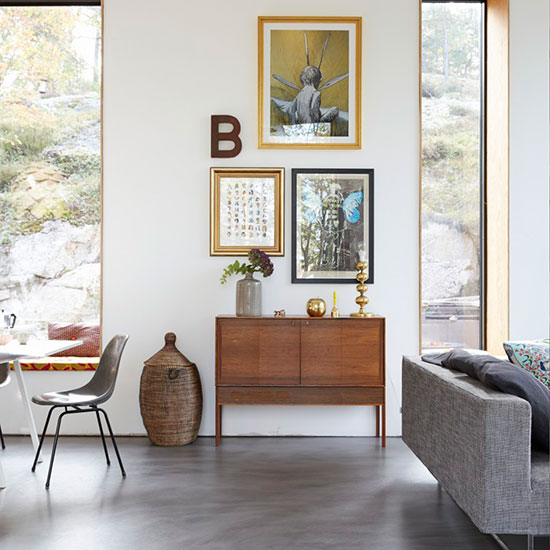 living room with photoframe on wall and flower in vase