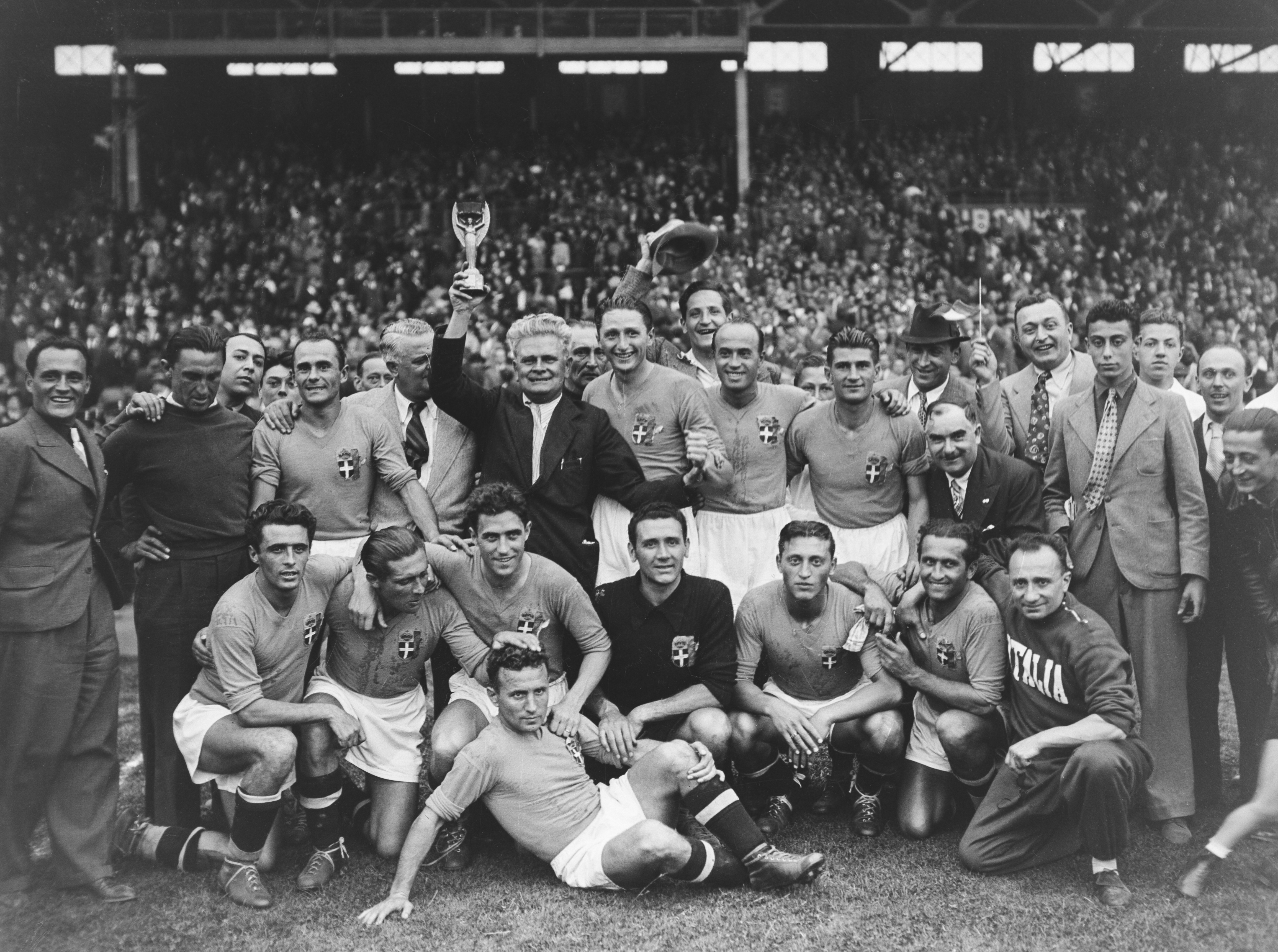 Italy coach Vittorio Pozzo holds the Jules Rimet trophy in a team photo after the Azzurri's 1938 World Cup win.