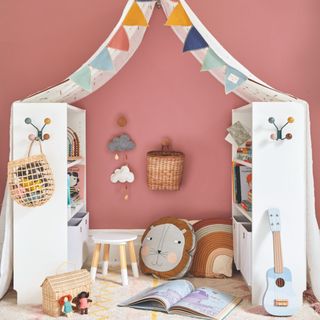 Toy room with DIY den made from bookcases and a sheet