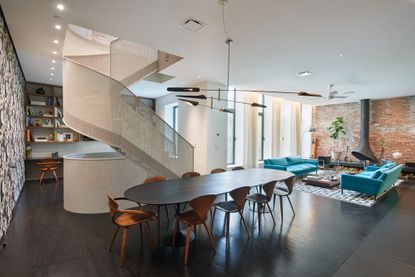 open plan living, study and dining room with a central white staircase