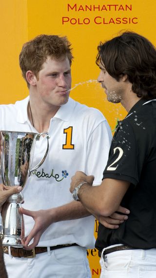 Prince Harry holding a silver trophy
