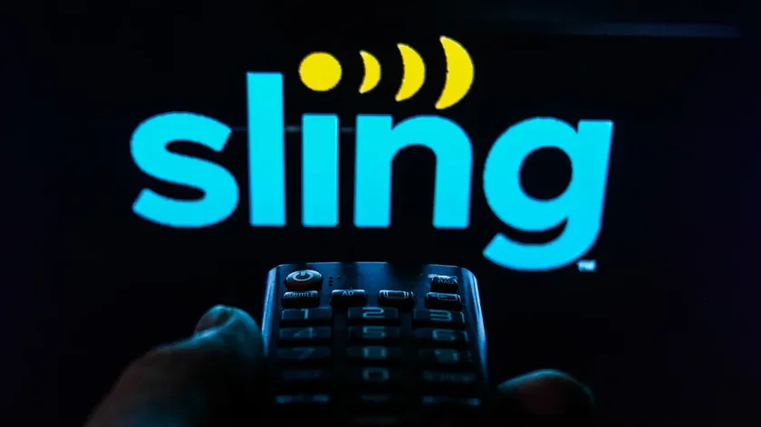 The Sling TV logo on a screen with a remote in front of it.