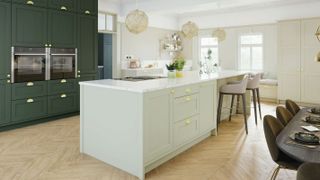 green kitchen with large kitchen island with white worktop