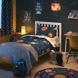 kids room with planet theme and bed on wooden floor