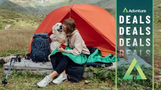Woman with golden retriever dog in tent