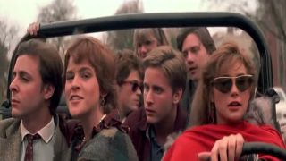 The cast of St. Elmo's Fire all riding in a Jeep together