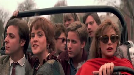The cast of St. Elmo's Fire all riding in a Jeep together