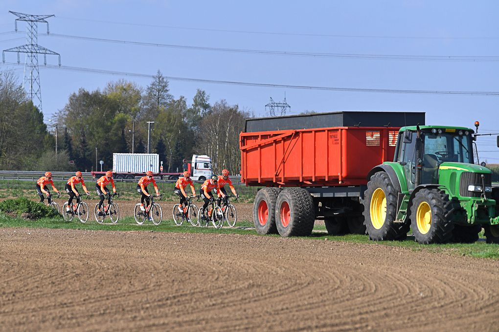CCC Team pass some local traffic on the Paris-Roubaix route
